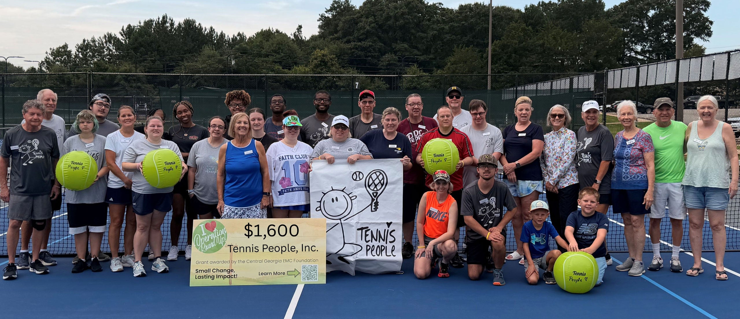 Tennis People accepting a check from the CGEMC Foundation