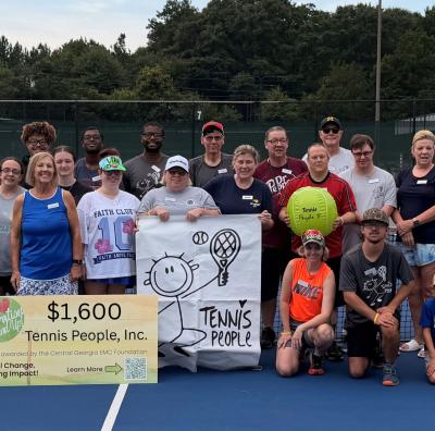 Tennis People accepting a check from the CGEMC Foundation